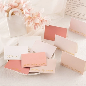 Detail of elegant gold-stamped cards with floral decor and artistic background accents