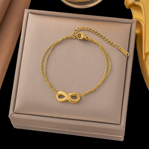 Golden double-layer infinity charm bracelet in a gift box with a high-polish finish