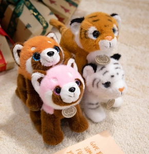Group of plush animal toys including tigers and pandas on a cozy carpet for gift display