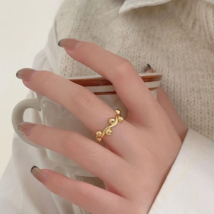 Elegant 925 sterling silver wave bead ring in gold finish worn in a lifestyle setting