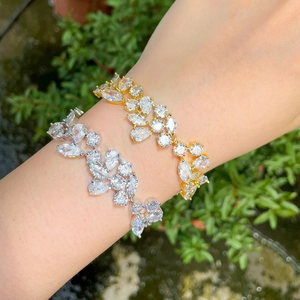 Detail shot of asymmetric leaf bracelets featuring sparkling marquise cut cubic zirconia