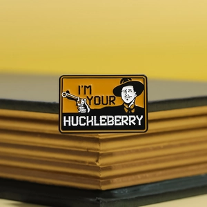 I'm Your Huckleberry enamel pin with quote and classic character on a book edge