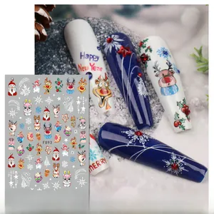 Macro view of Christmas nail art stickers featuring Santa, reindeer and snowflake patterns
