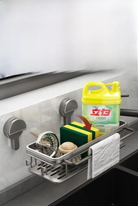 Detail view of the gray metal sponge holder and towel bar mounted on a tile wall