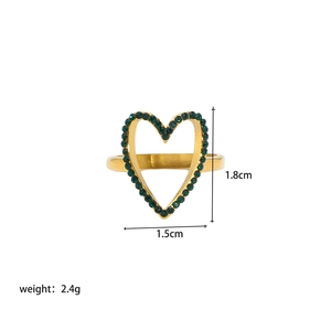 Macro view showing 1.8cm hollow heart ring dimensions and green crystal inlay details