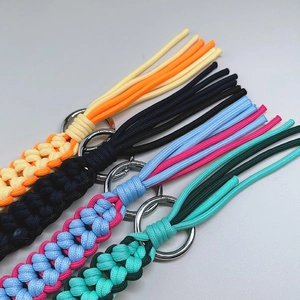 Colorful hand-woven paracord keychains with metal rings in various vibrant patterns