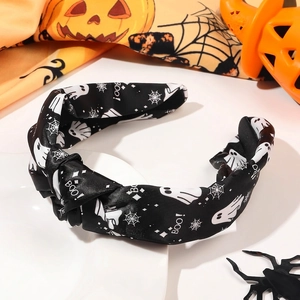 Detail of Halloween knot headband with white ghost spider web prints and Boo text