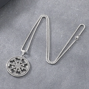 Macro detail of Viking Kolovrat pendant with antique silver finish and box chain