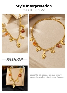 Detail of vintage gold plated necklace with musical note star and bow charms