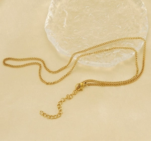 Detailed view of golden curb chain necklace with secure lobster clasp and extender