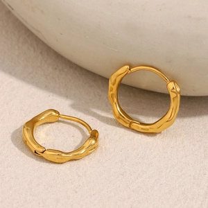 Detail showing irregular wavy texture on 18K gold plated stainless steel hoop earrings