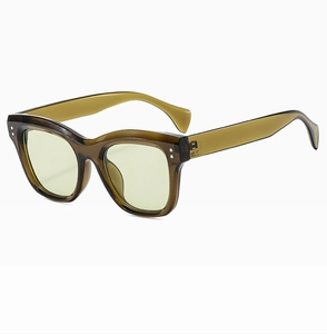 Macro side view of retro square tea-colored transparent sunglasses with light yellow lenses