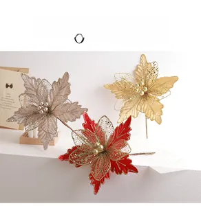 Detail of shimmering 24cm artificial mesh poinsettia flowers with glitter and pearl centers