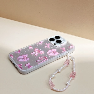 Detailed view of clear phone case with pink bow pattern and matching beaded wrist strap