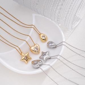 Minimalist gold and silver titanium necklaces with star, heart, and teardrop crystal pendants