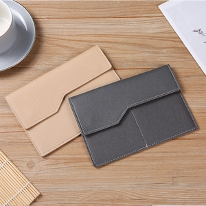 Flat lay of minimalist PU leather passport holders in light brown and dark grey colors