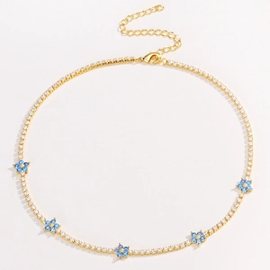 Close-up of golden necklace featuring a blue zircon flower with lobster clasp and chain