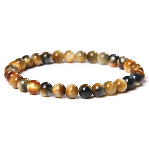 Macro detail of 8mm multicolored tiger eye beads with natural golden and blue textures