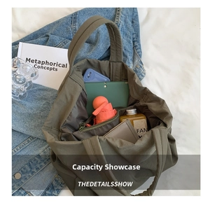 Inside view of olive nylon tote bag showing large capacity for tablet and daily items