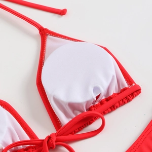 Detail view of red bikini top with white lining and removable round padding inserts