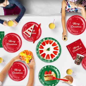 Detail of red and green striped Christmas tableware including paper plates and napkins