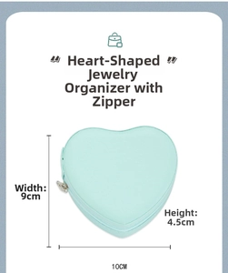 Detail view of mint green heart jewelry box with zip closure and 10x9x4.5cm dimensions