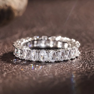 Macro detail of oval-cut stones in a classic eternity band with silver setting