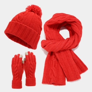 Detail of red cable knit set showing faux fur pom-pom hat and touch screen gloves