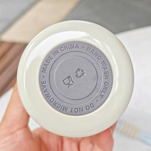 Detail of the non-slip silicone base on the cream white insulated stainless steel cup