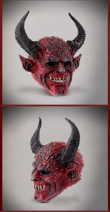 Detailed view of red devil mask featuring textured skin and curved black horns