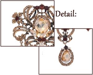 Detailed close-up of vintage palace style brooch with amber crystals and gold filigree