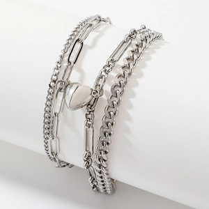 Detailed macro view of silver multi-layer chain bracelet with polished heart magnet