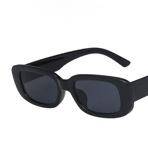 Detail view of vintage black square sunglasses with thick frames at a 45-degree angle