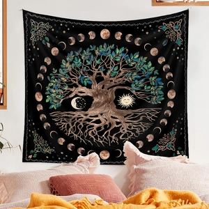 Detail of Bohemian tapestry with tree of life and moon phases hung in a cozy bedroom