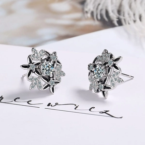 Elegant snowflake stud earrings with black drip glaze and sparkling cubic zirconia stones