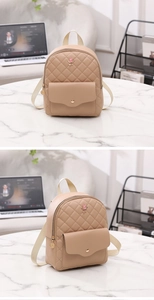 Detailed view of quilted khaki PU leather backpack featuring pink rose metal decoration