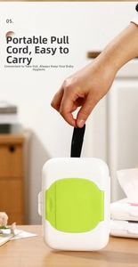 Detail of portable wet wipe box with green lid and black nylon carrying strap cord