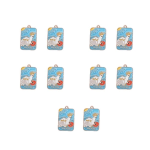 Macro view of ten enamel Tarot The Fool charms with white parrot motif and gold metal frames