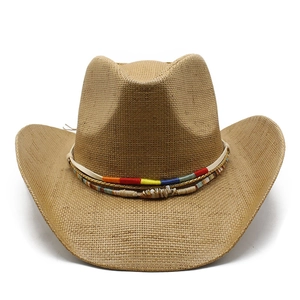 Brown woven straw cowboy hat with colorful ethnic band and shell trim on white background