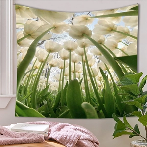 Detailed view of forest tulip tapestry with blue sky print hanging on a white bedroom wall