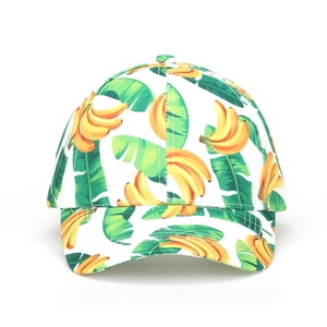 Detailed view of banana and palm leaf print on the crown of a white baseball cap