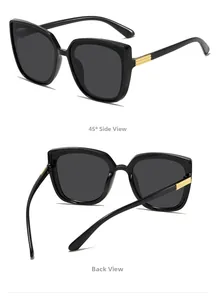 Detail view of square black sunglasses with gold metal temple accents and dark lenses