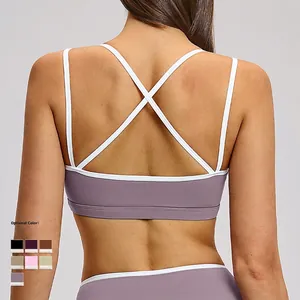 Purple contrast sports bra featuring thin criss-cross back straps and wide underband