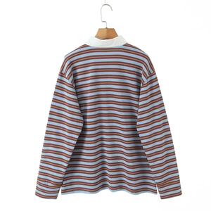Detailed shot of striped long sleeve polo shirt with classic collar on wooden hanger