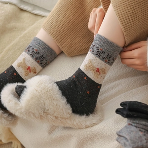Detail view of cozy wool socks with cute dog embroidery and stylish red bow accents