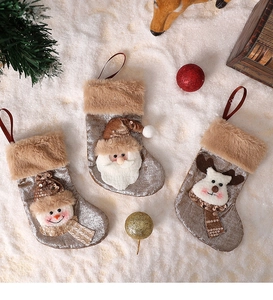 Detail of velvet Christmas stockings with 3D snowman, Santa, and elk embroidery