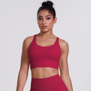 Detail of cross-back sports bra and high-waisted leggings in dark red brushed fabric
