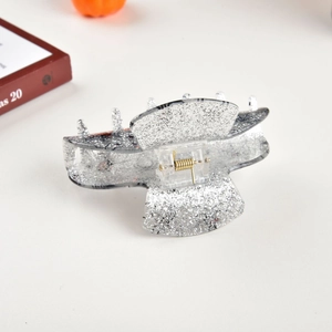 Detail of Halloween hair claw clip with silver glitter and black spider web pattern