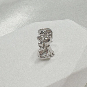 Macro shot of silver cartoon animal charm featuring high-polished finish and top loop