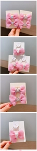 Detailed view of pink organza bow hair clip with sparkling rhinestone crown accent